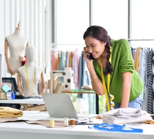 clothing designer talking to customer on phone
